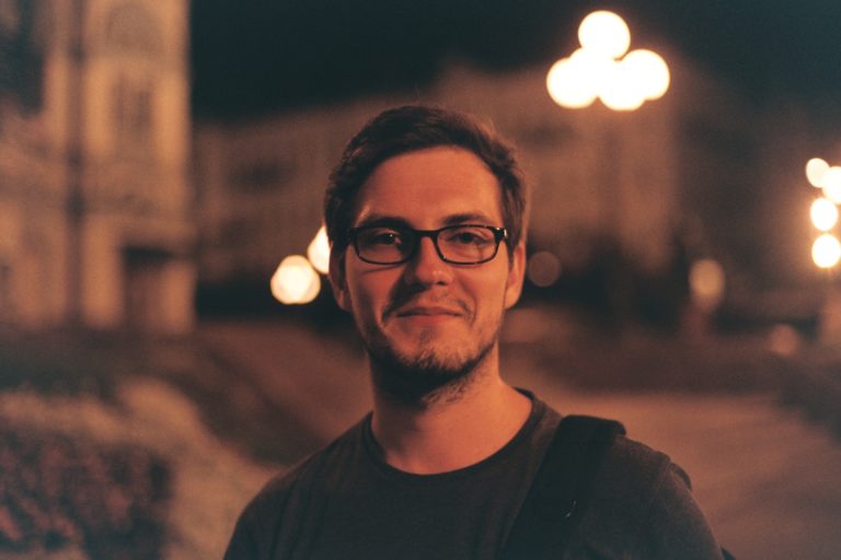 man in black crew neck shirt wearing black framed eyeglasses